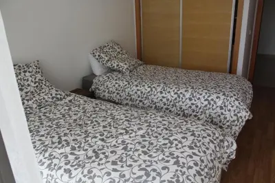 a bedroom with a bed with a black and white comforter at Appartement du bonheur Paradise in Mohammedia
