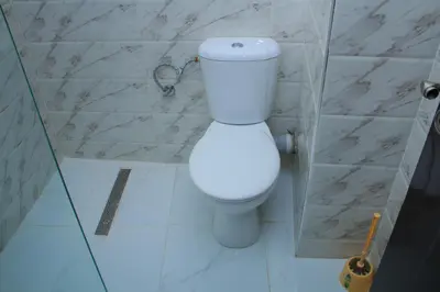 a bathroom with a white toilet in a stall at BOUZNIKA T1 in Bouznika