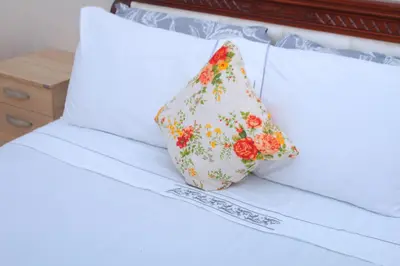 a pillow sitting on top of a bed at BOUZNIKA T2 in Bouznika