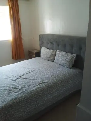 a bed with two pillows on it in a bedroom at Le Petit Havre de Joie BOUZNIKA in Bouznika