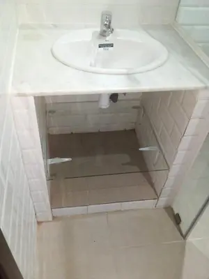 a bathroom with a sink and a mirror under it at Le Petit Havre de Joie BOUZNIKA in Bouznika