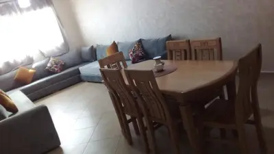 a living room with a table and chairs and a couch at Le Petit Havre de Joie BOUZNIKA in Bouznika