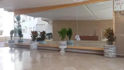 a lobby with a counter with potted plants on it at BOUZNIKA T10 in Bouznika