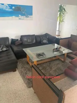 a living room with a couch and a coffee table at Appartement RIM in Casablanca