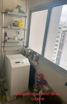 a small refrigerator in a room with two windows at Appartement RIM in Casablanca