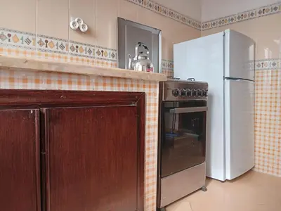 a kitchen with a stove and a refrigerator at Appartement près de casanearshore et l'OFPPT in Casablanca