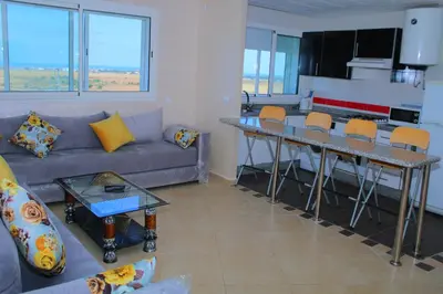 a living room with a couch and a table at BOUZNIKA Z2 in Bouznika
