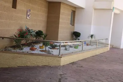 a balcony with a terrarium with plants in a building at Le chant de la rivière BOUZNIKA in Bouznika