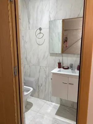 a bathroom with a toilet and a sink and a mirror at Magnifique F3 rénové Fibre, Parking & excellente desserte in Casablanca