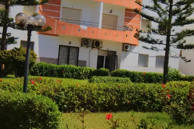 a building with a street light in front of a yard at Les temps heureux MOHAMMEDIA in Mohammedia