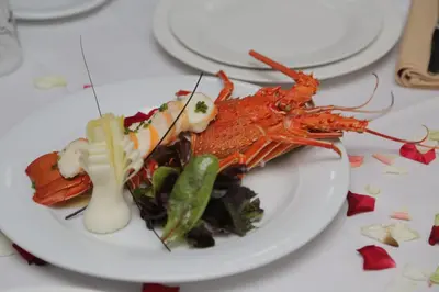 a plate of food with lobster on a table at Hotel Al Walid in Casablanca