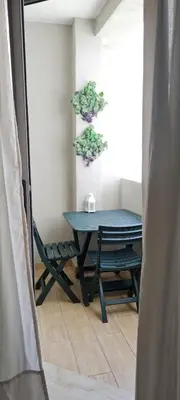a blue table and a chair in a room at Joli appartement Mohammédia in Mohammedia