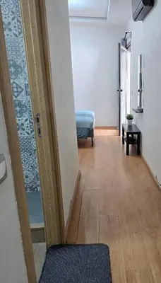 a hallway with a door leading to a bedroom at Joli appartement Mohammédia in Mohammedia
