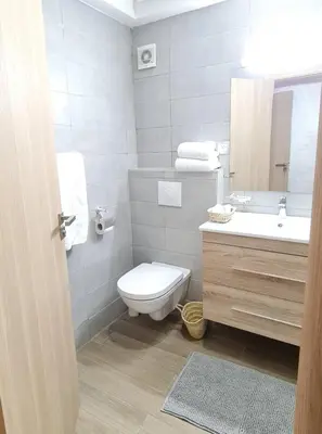 a bathroom with a toilet and a sink and a mirror at Joli appartement Mohammédia in Mohammedia