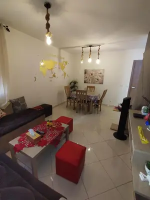a living room with a couch and a table at Spacious 2BR Ground-Floor Apartment Parking & Free Wi-Fi in Casablanca