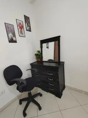 a desk with a chair and a mirror at Spacious 2BR Ground-Floor Apartment Parking & Free Wi-Fi in Casablanca