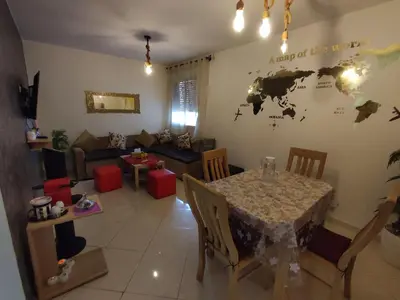 a living room with a table and a couch at Spacious 2BR Ground-Floor Apartment Parking & Free Wi-Fi in Casablanca