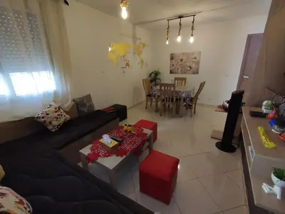 a living room with a couch and a table at Spacious 2BR Ground-Floor Apartment Parking & Free Wi-Fi in Casablanca