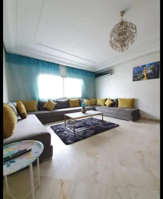 a living room with a couch and a table at Résidence jnane California in Casablanca