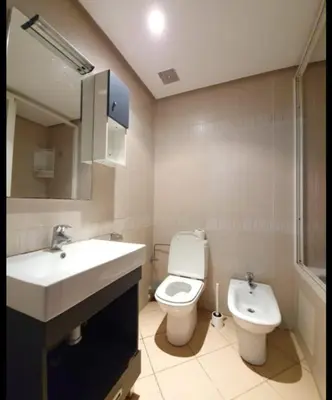 a bathroom with a sink and a toilet and a mirror at Résidence jnane California in Casablanca