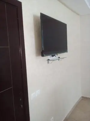 a flat screen tv hanging on a wall at Séjour à Bouznika in Bouznika