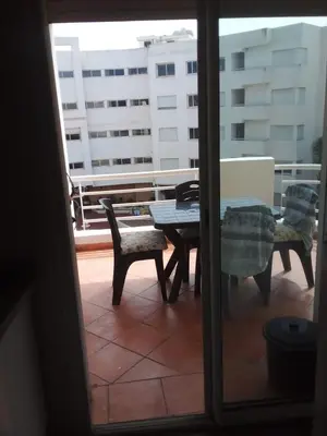 a view of a patio with a table and chairs at Appartement 2 chambres Bouznika in Bouznika