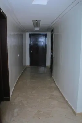 a hallway with a black door in a building at BOUZNIKA CH1 98 in Bouznika