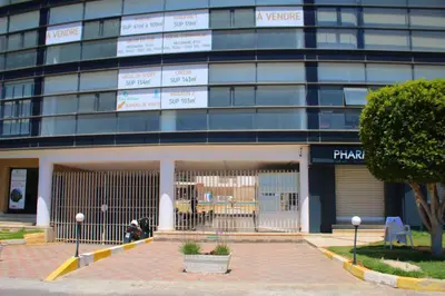a building with a parking lot in front of it at BOUZNIKA CH1 98 in Bouznika