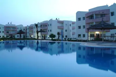 a large swimming pool in front of some buildings at Magnifique Appartement MOHAMMEDIA in Mohammedia