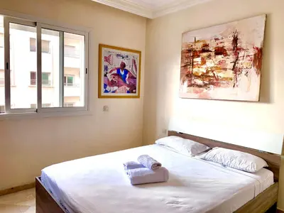 a bedroom with a bed with a towel on it at Sab 8 - Amazing view. 2 bedrooms in front of the mosque Hassan. Perfect location in Casablanca