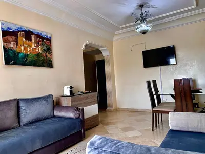 a living room with a couch and a table at Sab 8 - Amazing view. 2 bedrooms in front of the mosque Hassan. Perfect location in Casablanca