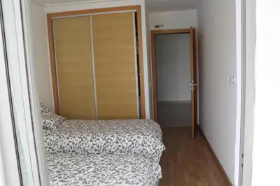 a bedroom with a bed and a sliding glass door at MOHAMMEDIA Paradise Beach in Mohammedia
