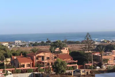 a town with houses and the ocean in the background at MOHAMMEDIA Paradise Beach in Mohammedia
