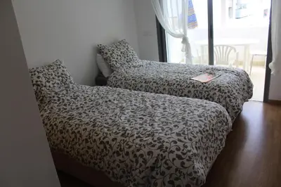 a couch in a room with a blanket and a book at Paradise BEACH in Mohammedia