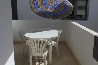 a table and two chairs and a plate on a window at Paradise BEACH in Mohammedia