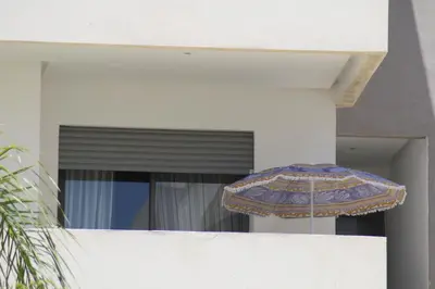 an umbrella sitting on the side of a building at MOHAMMEDIA L Oasis maritime in Mohammedia