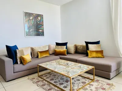 a living room with a couch and a coffee table at Melrose Beαch Aρραrt Pοοl Vieω in Casablanca