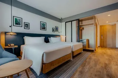 a hotel room with a large bed and a couch at Hilton Garden Inn Casablanca Sud in Casablanca