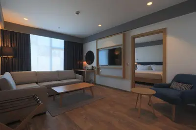a living room with a couch and a bed at Hilton Garden Inn Casablanca Sud in Casablanca