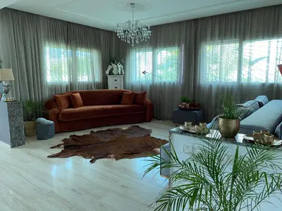 a living room with a couch and a wooden floor at Skhirat VILLA Zhor in Skhirat
