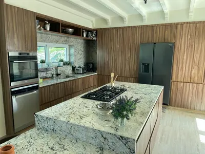 a kitchen with a granite counter top and a stove at Skhirat VILLA Zhor in Skhirat