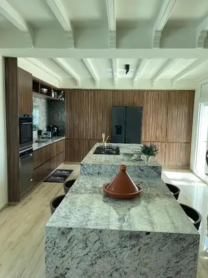 a large kitchen with a large marble counter top at Skhirat VILLA Zhor in Skhirat