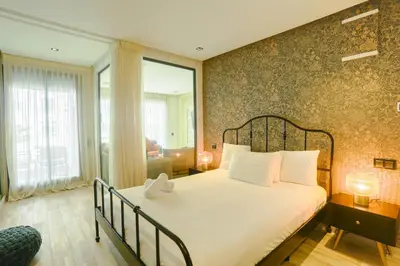 a bedroom with a large bed with a large window at Tantan golden 5 not far from beach in Casablanca