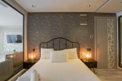 a bedroom with a large white bed with two lamps at Tantan golden 5 not far from beach in Casablanca