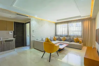 a living room with a couch and a table at Massira Diamond Maarif- Parking-wifi-self check in in Casablanca