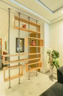 a living room with a book shelf and a couch at Racine spacious 2 bedrooms near twin center#Freewifi#freeparking in Casablanca