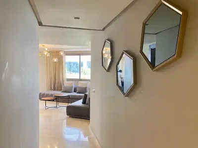 a living room with a couch and a mirror at #26 Maarif urban Massira near twin center casablanca in Casablanca