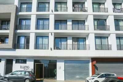a white building with cars parked in front of it at Lavish Flat in new city #fastwifi#Parking in Casablanca