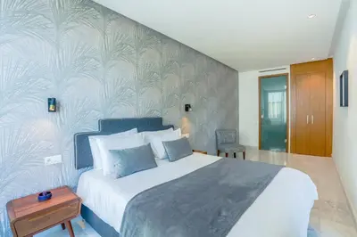 a bedroom with a large bed and a wall at Lavish Flat in new city #fastwifi#Parking in Casablanca