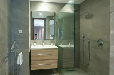 a bathroom with a shower and a sink and a mirror at Lavish Flat in new city #fastwifi#Parking in Casablanca